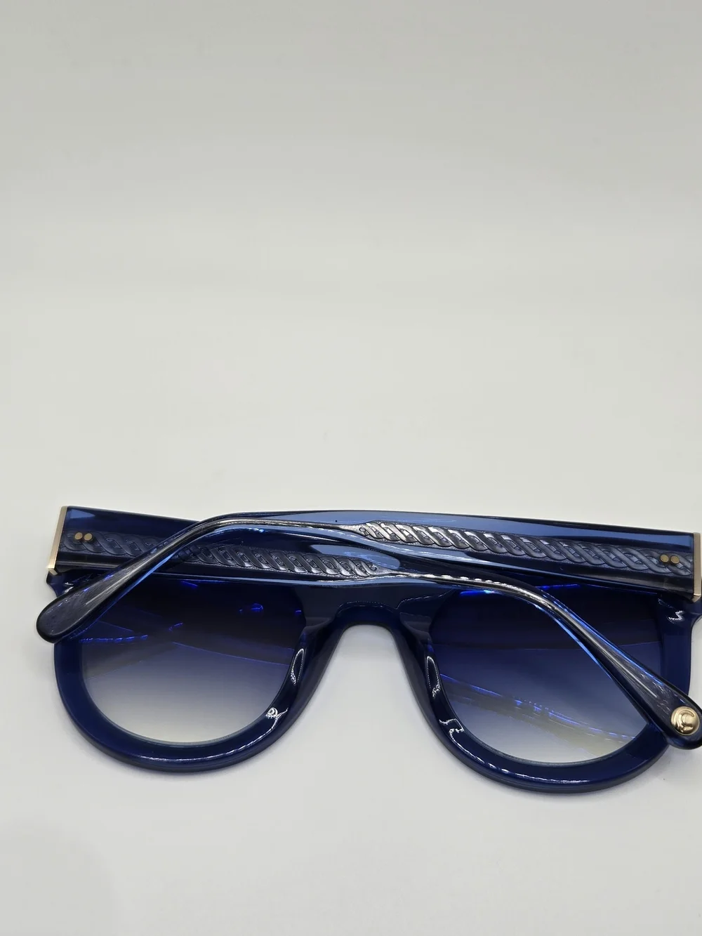 Aperçu sunglasses featuring a bold acetate frame and gold tone branding